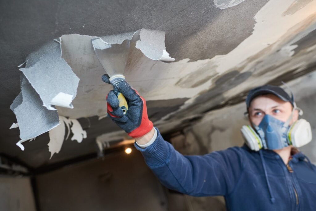 fire damage and restoration indoor interior. removing damaged paint layer